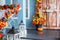 Cozy porch of the house with wooden lanterns in fall time. Halloween design home with yellow fall leaves and lamps. House entrance