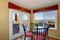 Cozy red and yellow dining area with table set.