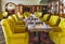 Cozy restaurant interior with upholstered yellow furniture in Castle SPA Wagenkull