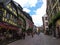Cozy restaurants decorated with flowers and houses with colorful facades in the streets of Riquewihr