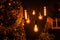 Cozy room with a Christmas tree with golden garlands with vintage lamps with mirror balls with yellow light in the evening time.