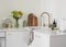 Cozy scandinavian style kitchen interior - bouquet of hydrangeas and daisies vase, cutting boards, kettle, kitchen utensils on the