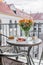 Cozy shot of outdoor balcony with fruit and sweet on table in background of buildings