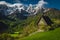 Cozy small hut on the slope and snowy mountains, Slovenia