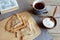 Cozy snack with Russian style pancakes and book during Maslenitsa Old wooden background