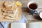 Cozy snack with Russian style pancakes and book during Maslenitsa Old wooden background