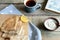 Cozy snack with Russian style pancakes and book during Maslenitsa Old wooden background