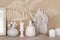 Cozy and soft home decor concept. vases with dried grass, candles, small statue, mirror and wooden frame