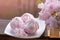 Cozy spring still life: cup of hot tea with spring bouquet of flowers on vintage windowsill with a pink marshmallow