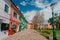 Cozy street with park near colorful private houses of Burano island on sunny day