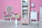 Cozy stylish vintage corner of the pink bedroom with floor vase