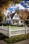 cozy suburban home with white picket fence