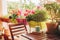 Cozy summer balcony with many potted plants