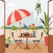 Cozy summer balcony with parasol, small table, chair and pots of flowers. Summer time Idyllic seating in the terrace with drink.