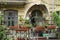 Cozy terrace of an old house surrounded by flowerbeds.