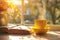 Cozy warm composition with yellow cup of hot coffee or tea and a book on sunny windowsill on spring day. Spring home decor. Easter