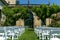 Cozy wedding ceremony with a flower arch and wooden white chairs in an Italian villa. Without people