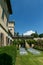 Cozy wedding ceremony with a flower arch and wooden white chairs in an Italian villa. Without people