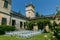 Cozy wedding ceremony with a flower arch and wooden white chairs in an Italian villa. Without people