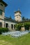 Cozy wedding ceremony with a flower arch and wooden white chairs in an Italian villa. Without people