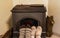 Cozy winter concept: two pairs of foots in wool socks in front of the old iron stove