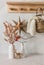 Cozy winter interior - dried flowers in a vase, a homemade scandinavian christmas star, books, christmas decorations, a knitted