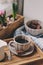 Cozy winter morning at home. Coffee, milk and chocolate on wooden tray. Huacinth flowers on background. Warm mood