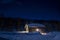 Cozy Wintry Ski Resort Cottage Snowcapped roof and blue starry Sky.