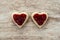 Cozy wooden background, with 2 heart-shaped sandwich bread with strawberry jam in the center, love concept, for Valentine`s Day,