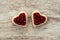 Cozy wooden background, with 2 heart-shaped sandwich bread with strawberry jam in the center, love concept, for Valentine`s Day,