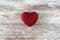 Cozy wooden background, with a red heart with glitter in the center, love concept, for Valentine`s Day, Mother`s Day, Father`s