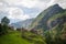 cozy wooden houses on green hill in majestic mountains Aurlandsfjord Flam