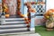 Cozy wooden porch of the house with pumpkins in fall time. Halloween design home with yellow fall leaves and lanterns.