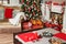 Cozyness and home comfort. Sofa near the decorated Christmas tree and fireplace with firewood. Winter holidays room interior, Chri