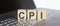 CPI abbreviation written on a wooden cube on laptop