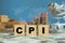 CPI, consumer price index symbol.Wooden block with words CPI with shopping basket and stack coin background, consumer price index