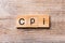 CPI word written on wood block. abbreviation consumer price index text on wooden table for your desing, concept
