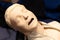 CPR first aid resuscitation adult man life size training dummy model, doll face closeup, detail, mannequin mouth wide open