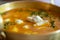 Crab curry with betel leaves in a brass pan at restaurant