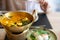 Crab curry with betel leaves in a brass pan at restaurant