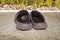 A crab hidden in beach shoes on the sand