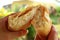 Crab meat filled Empanada or Empanada de Jaiba cut in half being held in hands, delicious Chilean puff pastry