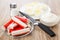 Crab sticks in saucer, peeled eggs, mayonnaise, salt and knife