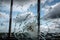 crack in glass windowpane, with view of stormy sky and thunderclouds