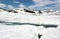 The crack in the ice, the snow-covered lake and the mountains, Norway