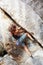 Into the crack. A rock climber trying to get a grip in a crack of cliff face.