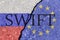 The crack between the Russian Federation and European Union flags. The concept of disconnecting Russia from SWIFT by the European