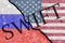 The crack between the Russian Federation and USA flags. The concept of disconnecting Russia from SWIFT by the USA