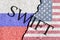 The crack between the Russian Federation and USA flags. The concept of disconnecting Russia from SWIFT by the USA