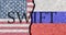 The crack between the Russian Federation and USA flags. The concept of disconnecting Russia from SWIFT by the USA